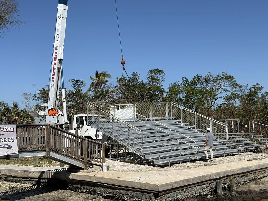 Sutter Roofing came to the aid of the Ski-A-Rees water ski team recently with the company's massive crane to help lift the bleachers out of the water. The bleachers had blown into Sarasota Bay as a result of Hurricane Milton.