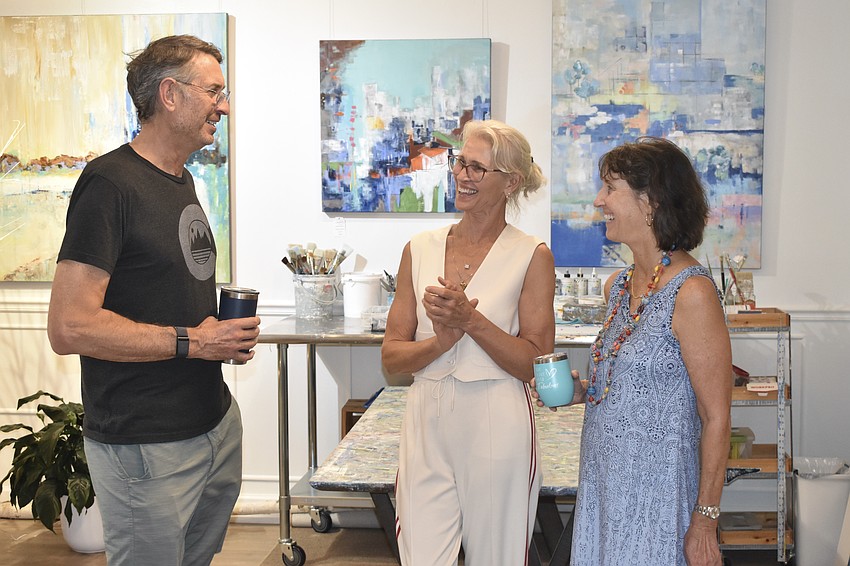 Doug Doolittle, artist Meg Krakowiak and Elizabeth Rand talk inside Meg Krakowiak Art Gallery & Studio.