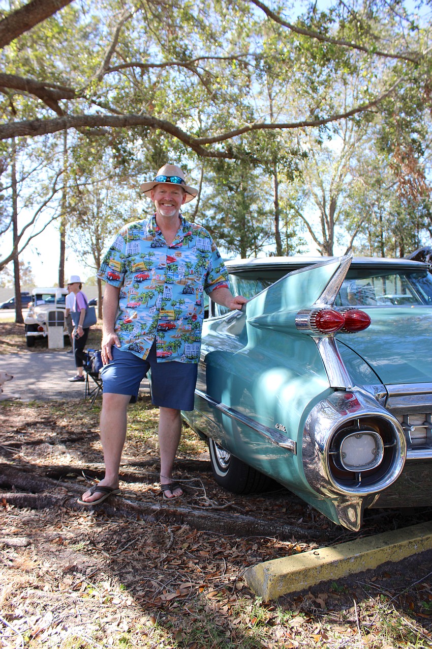 Palmetto's Kelvin Etchison stands next to the distinctive fins of his 1959 Cadillac Deville at the Knights Car Show.