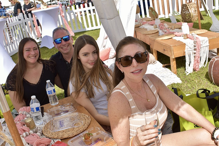 Kelsey Mitchell, Gerard Sola, Audrey Scudder and Jeanine Messana enjoy the VIP tent. Mitchell is the current District Governor of Rotary, and Sola is the next in line.