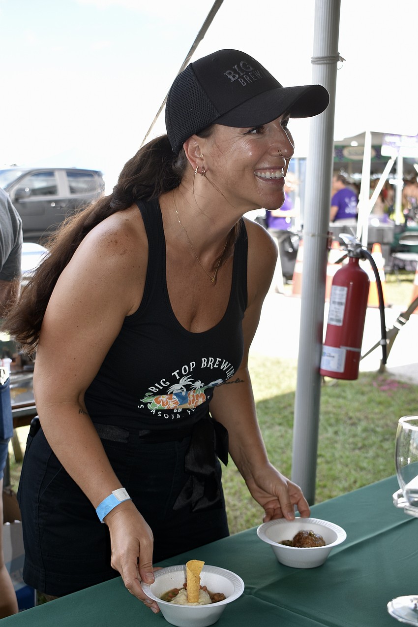 Camille Perkins offers guests a choice between white chicken chili and chicken meatballs from Big Top Brewing.
