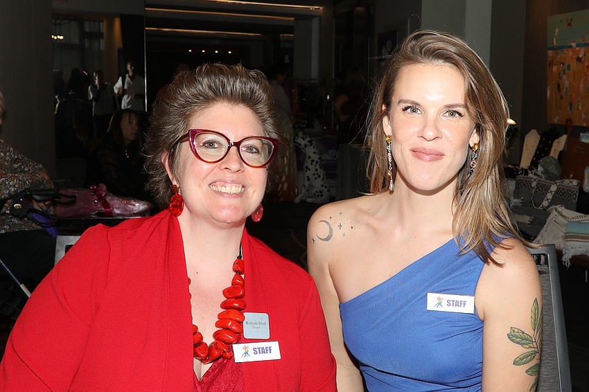 Artist volunteers Robyn Holl and Rose Gwynn work the registration desk.