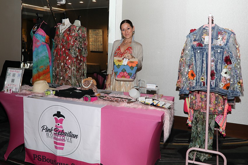 Terri Tominelli sets up a fashion booth highlighted in pink with many designs from Europe.