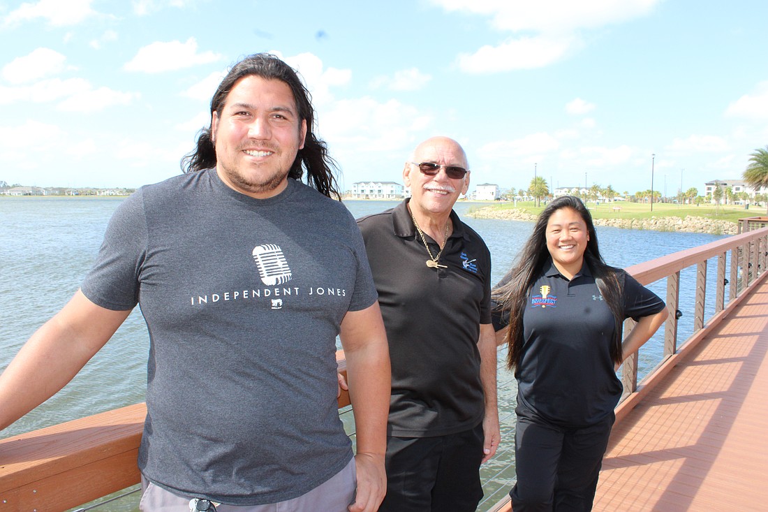 Independent Jones' Antonio Hernandez, Paul Benjamin of Benjamin Productions and Independent Jones' Morgan Bettes Angell stand at the bridge leading into Waterside Park. The bridge will serve as the entrance into the Lakewood Ranch Blues Festival Dec. 7.