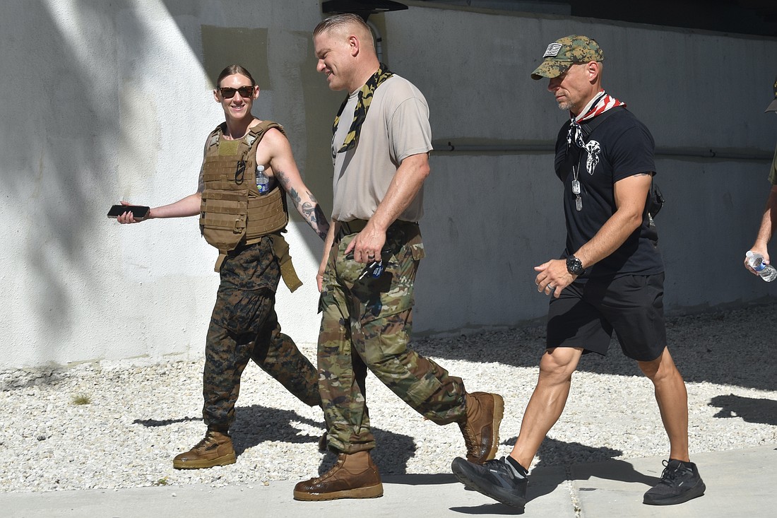 Carly Weakland of Veterans Affairs Law walks with Anthony Kuhn and his longtime friend from the U.S. Army, Wayne Robinson, in the 2023 Memorial Day Hike by SRQVets.