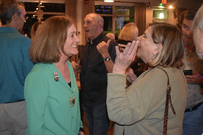 Kathy Kelley Ohlrich is congratulated by Joyce Cloutier.