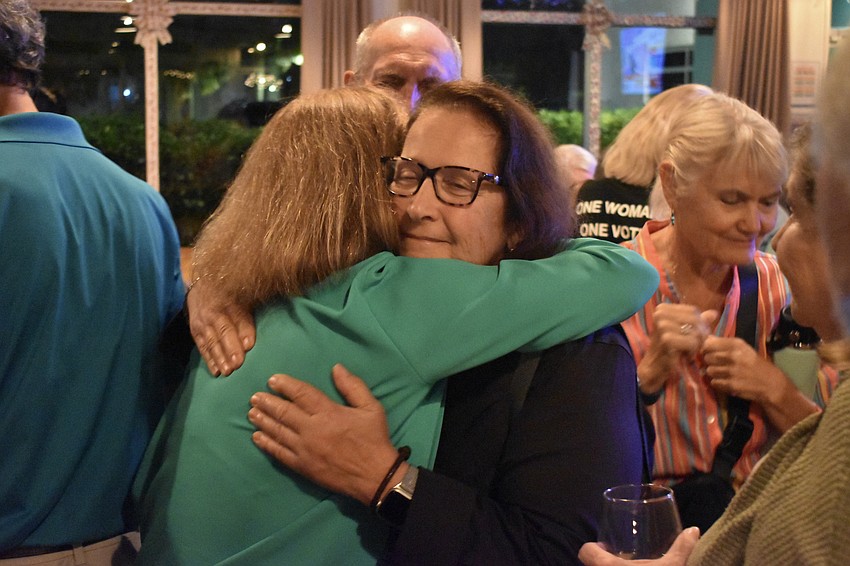 Kathy Kelley Ohlrich is congratulated by Virginia Hoffman.