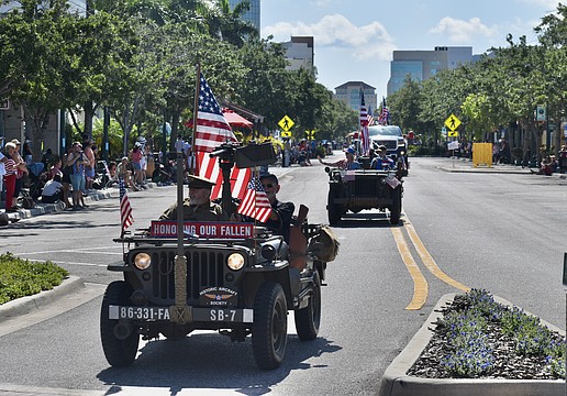 A vehicle representing the Historic Aircraft Society arrives at the Main Street and Orange Avenue roundabout during the Memorial Day parade in 2024.