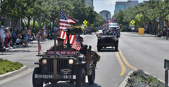 A vehicle representing the Historic Aircraft Society arrives at the Main Street and Orange Avenue roundabout during the Memorial Day parade in 2024.