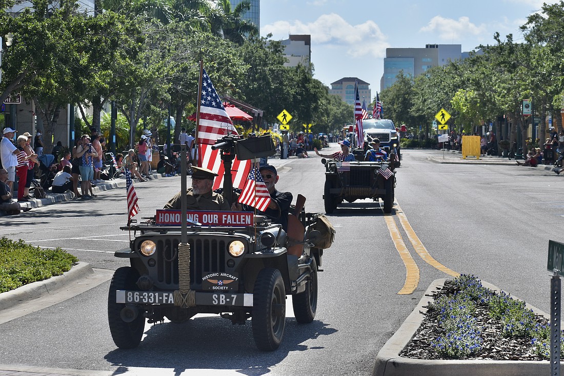 A vehicle representing the Historic Aircraft Society arrives at the Main Street and Orange Avenue roundabout during the Memorial Day parade in 2024.
