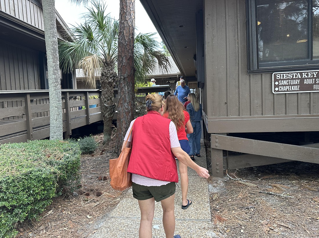 People line up to vote at the polling station at Siesta Key Chapel Tuesday afternoon.