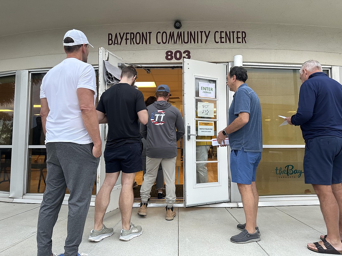 Voters enter the polling place at the Bayfront Community Center moments after the polls opened on Election Day, Nov. 5.