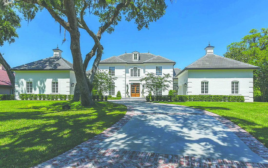 Plantation at Ponte Vedra Beach two-story home with golf course views features four bedrooms, three full and one half-bathrooms, wine room, pantry, exercise room, generator, porches and pool.