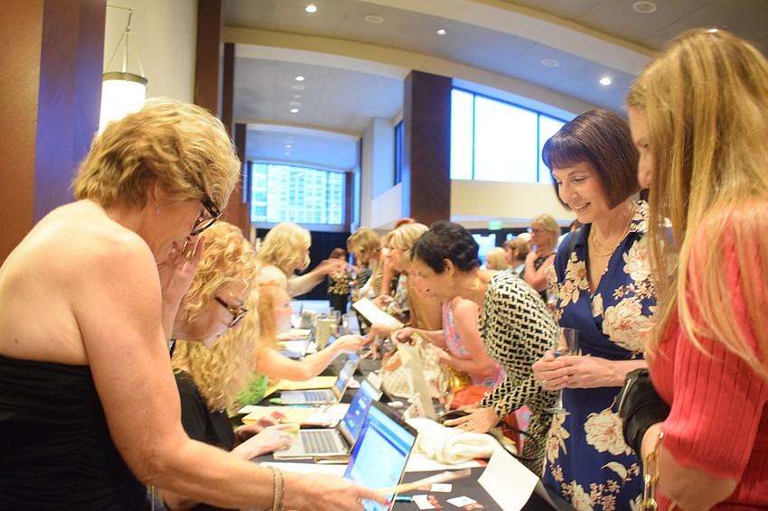 Women line up to check in for Designer Bag Bingo. At least 230 women attended the popular Sisterhood for Good event.