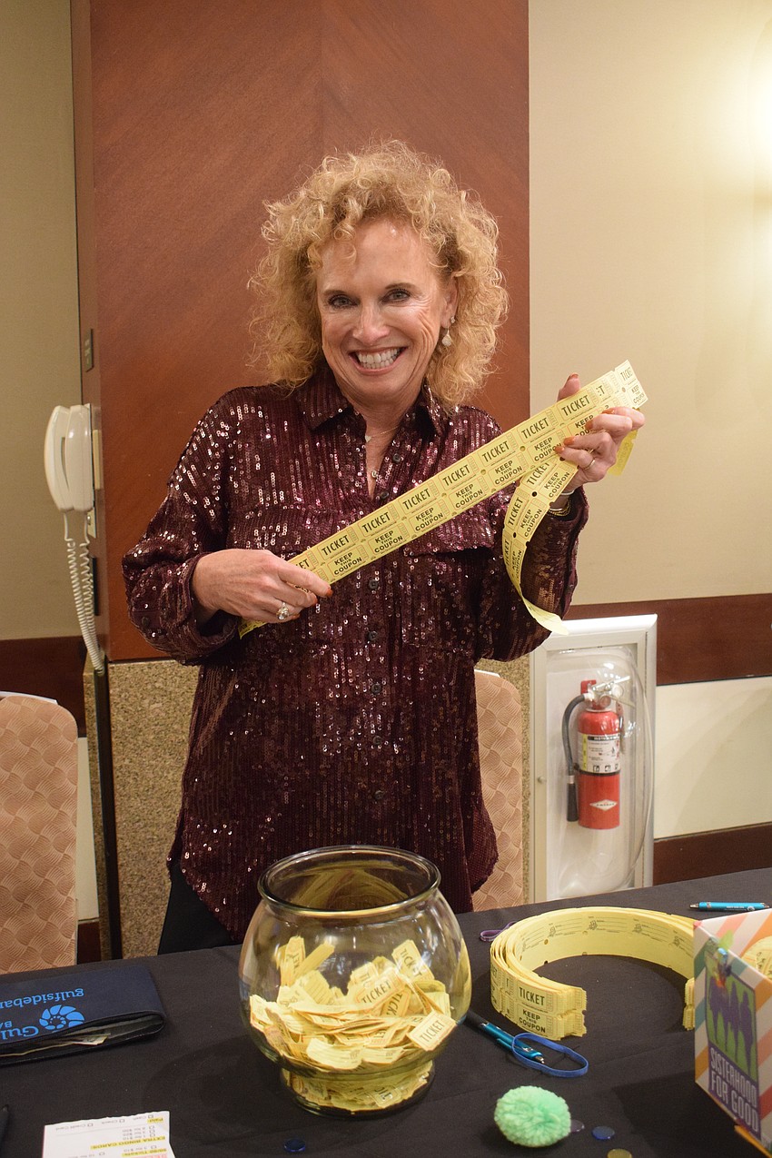 Anne LeBaron with Take Stock in Children is all about selling 50/50 raffle tickets.