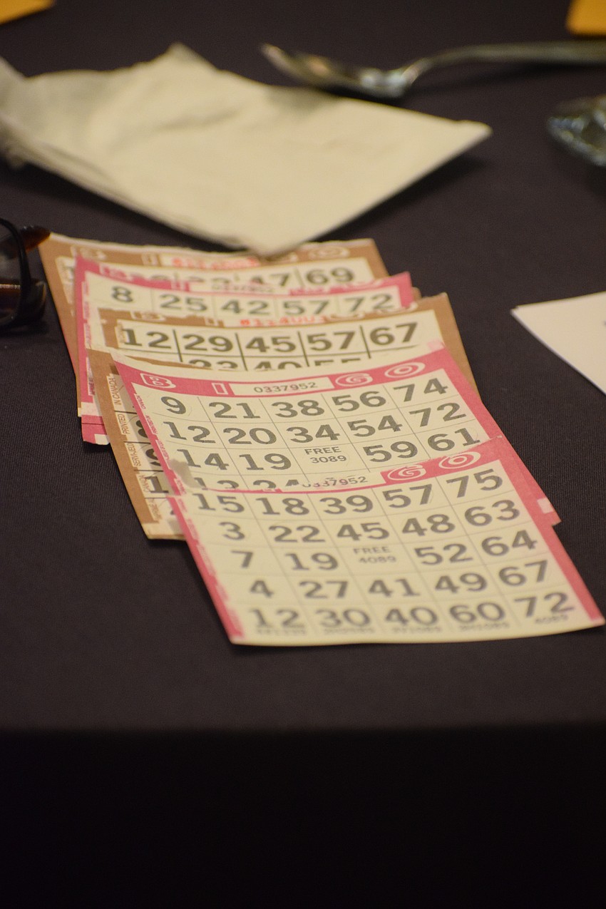 The bingo cards are being laid out. Every card means a chance to win a designer bag.