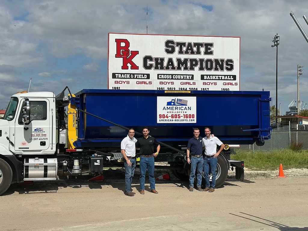 Father-and-son teams (from left) Ramzy and Syrus Bakkar and Ben and David Heekin partnered in 2024 to launch the Jacksonville-based American Rolloffs dumpster service. Both fathers have been close friends since childhood, as have the sons. All graduated from Bishop Kenny High School.