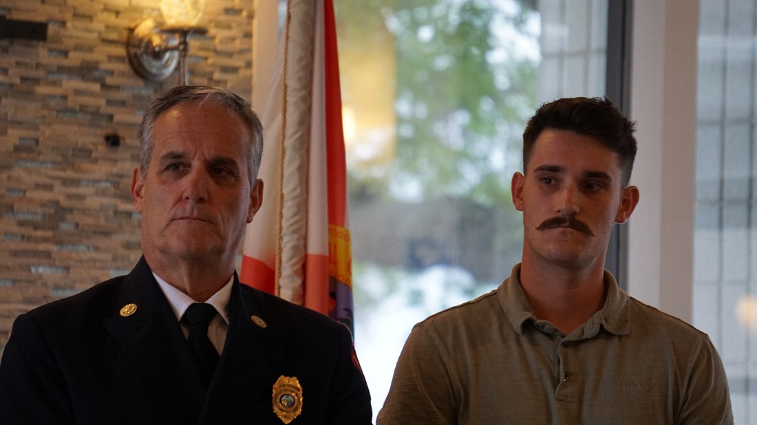 Fire Chief Paul Dezzi and his son, Ryan, were recognized for saving their neighbor from cardiac arrest while off-duty.