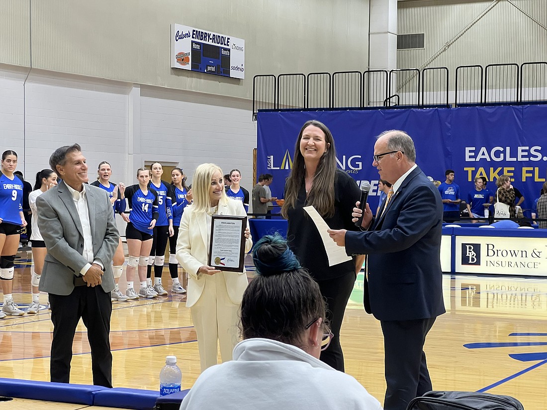 School Board member Carl Persis, Ormond Beach City Commissioner Susan Persis, Coach Joslynn Gallop and Ormond Beach Mayor Bill Partington, who is reading her proclamation. Courtesy photo