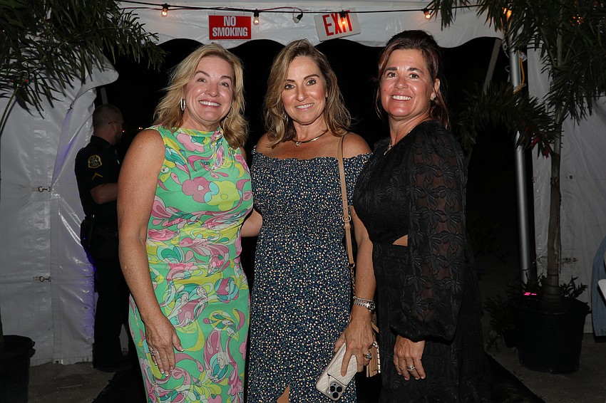 Susan Hines, Lori Turkovics and April Kidwell beam with bright smiles at this super-energetic event.