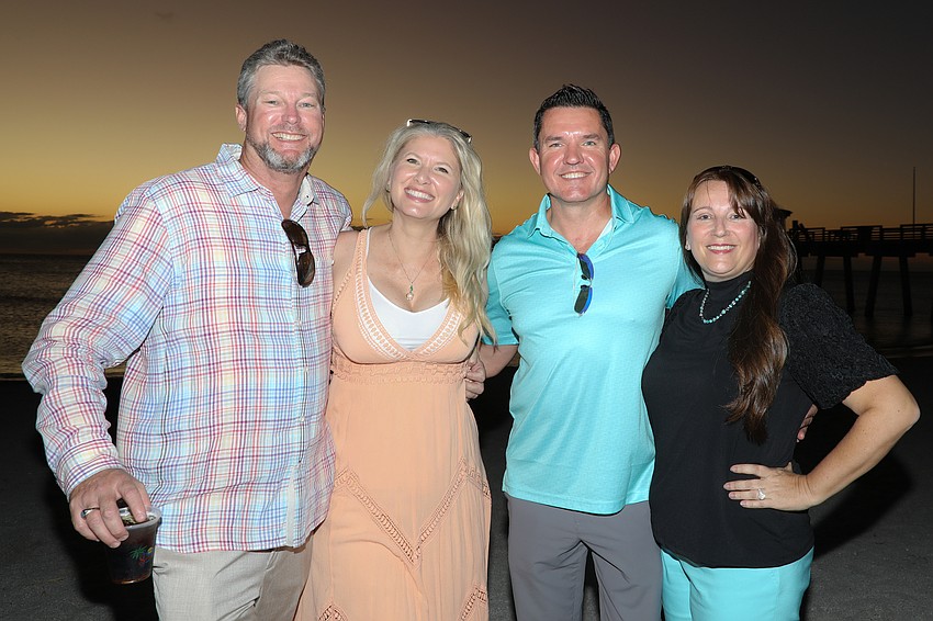 Having fun in the sand at sunset are Erik and Camilla Popham and Mark and Kathleen Lyda.