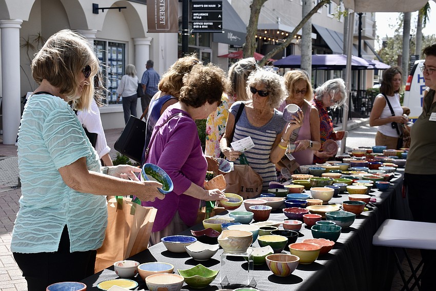 Guests decide on which bowl to take home from Empty Bowls on Nov. 8.