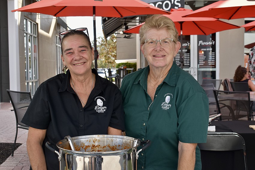 Rita Lewis, owner of the Linger Lodge, and Gretchen Nasman serve gumbo.