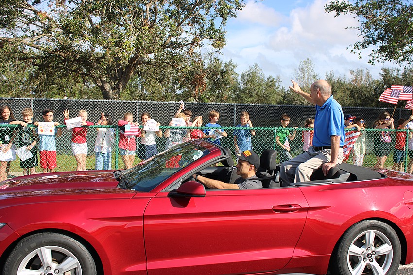 Marines Lt. Col. Paul Gulbrandsen drives Air Force E-4 Bill Danowski during the parade at McNeal.