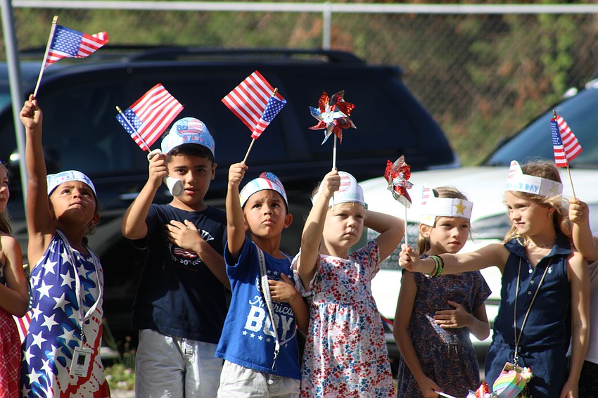 Students at Gilbert McNeal Elementary salute the veterans who participated in the school's Veterans Day parade.
