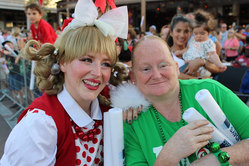 Cindy Lou Who gives a hug to Bradenton's Renee Cryan before the Santa's Grand Arrival Parade.
