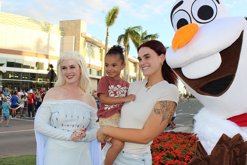 Lakewood Ranch's Rylynn and Delany Morehart find themselves between a couple of cool characters during the Santa's Grand Arrival Parade at the Mall of UTC Saturday.