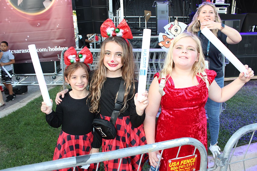 Brianna and Kaylee Casablanca, and Aubrielle Deaugustinis have their light sticks ready for the start of the parade.