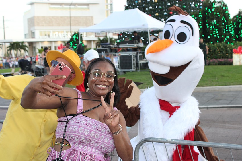 Sarasota's Shantel Norman, who sang the National Anthem at the event, has a little fun with one of the characters.