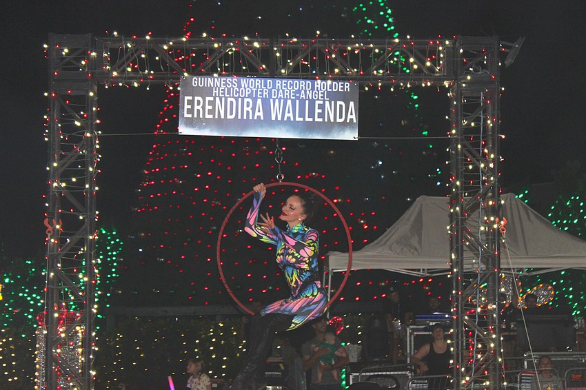 Erendira Wallenda rode in the Santa's Grand Arrival Parade after performing some amazing acrobatic stunts while hanging below a helicopter that hovered over the parade site.