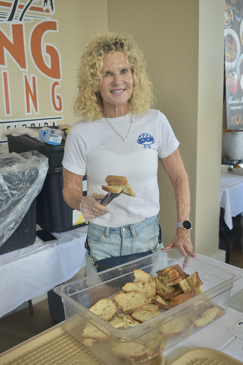Debra Thuet, whose son Jules Thuet co-owns Bread Bandits, offers a piece of its organic bread.