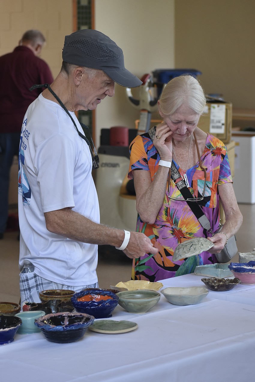 Don and Barbara Pelersi browse the bowls.