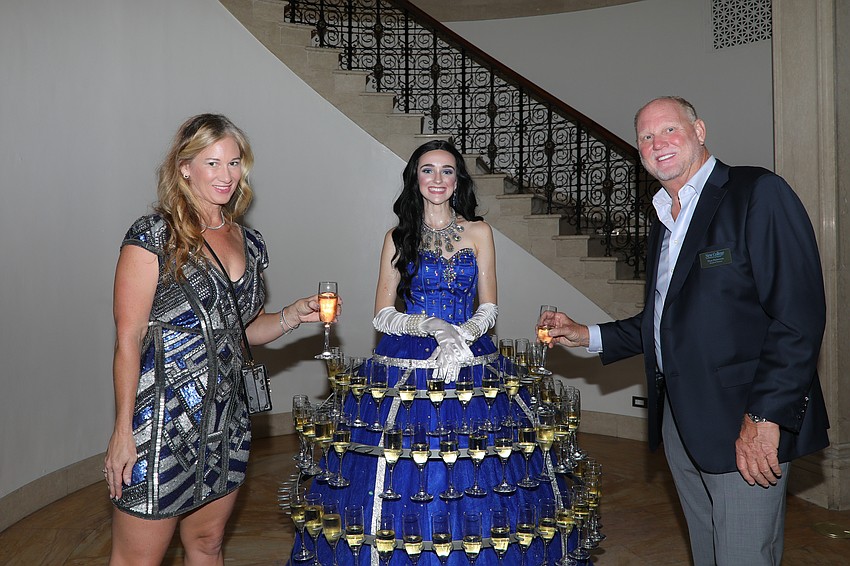 AVP Advancement Jennifer Groff, champagne model Shianne Akers, and event co-chair Don Patterson.