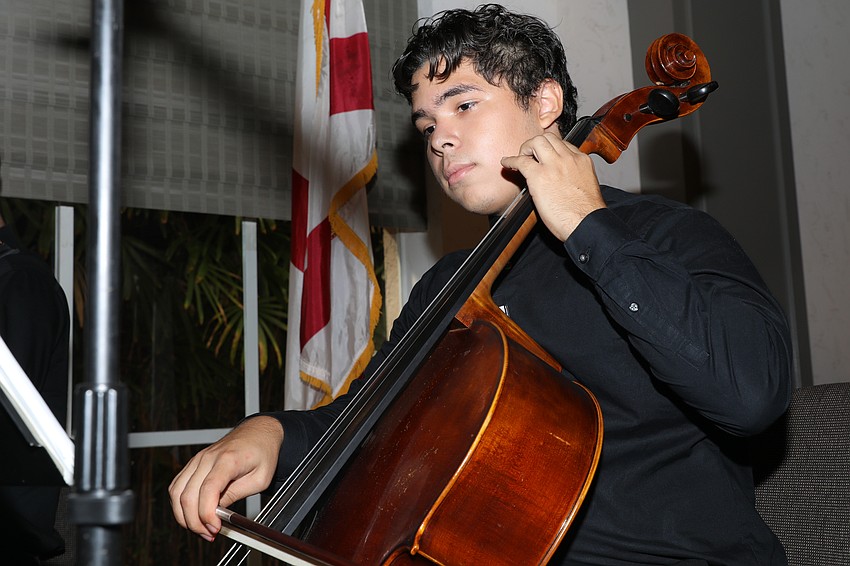 Music major Albert Molina-Sierra plays for attendees.