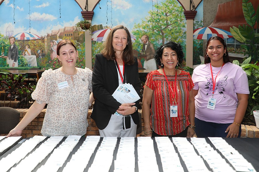 Check-in volunteers Madeline Mangas, Susanne Walters, Carmen Wiersema and Scarlet Benamor.