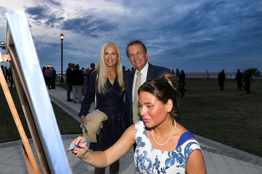 Maryl and Bill Henry stop to watch artist Lucy Duke paint.