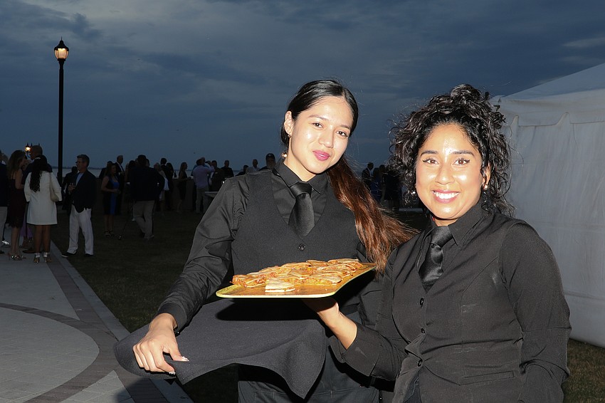 Cielo Mechan and Kendal Alva from Michael's on East serve small bites during the cocktail hour.