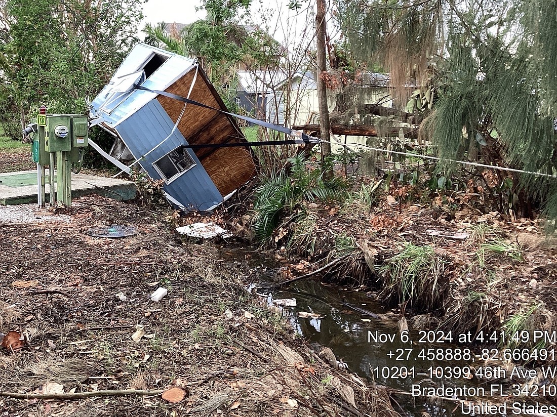 An entire shed is pulled out of a canal on Nov. 6 by Manatee County's Stormwater Division.