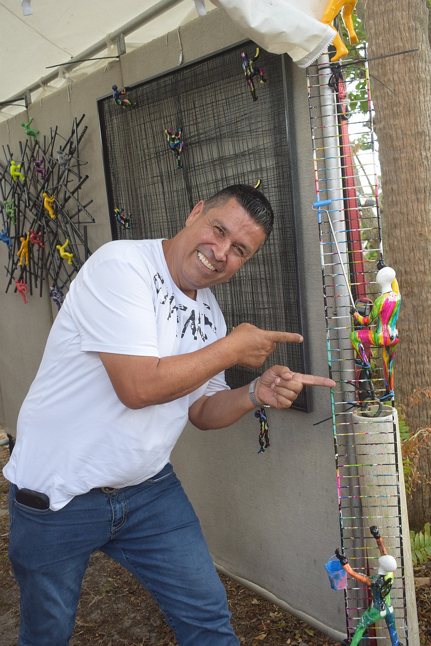 Miami artist Ancizar Marin at St. Armands Circle Art Festival.