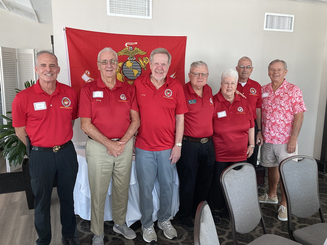 The uniform of the day for the Marine veterans — red polo shirts with the Marine Corps emblem. From left, David Matthews, Doug Rigg, Art Dehardt, Bob Fields, Debbie Fields, Joe Felice and David Doak.