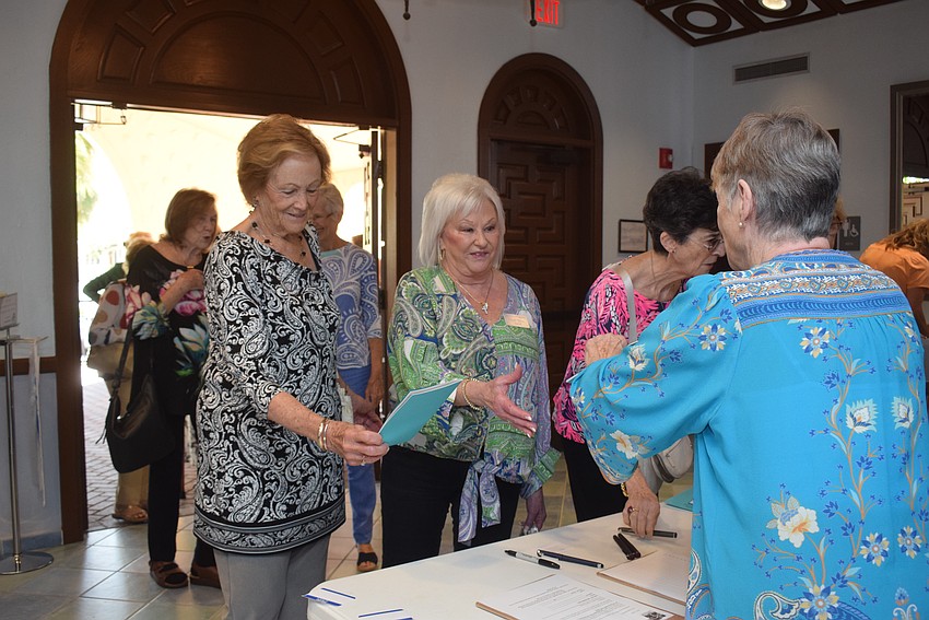 Cindy Noble and Linda Olsen checking in at the St. Marys Women's Guild welcome back lunch.