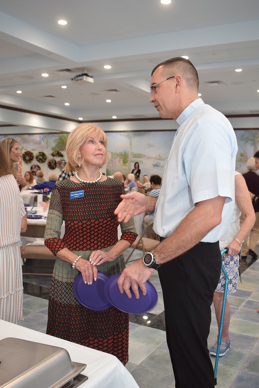 Susan Gilmore-Clarke talking to the Rev. Robert Dziedziak at the St. Marys Women's Guild welcome back lunch.