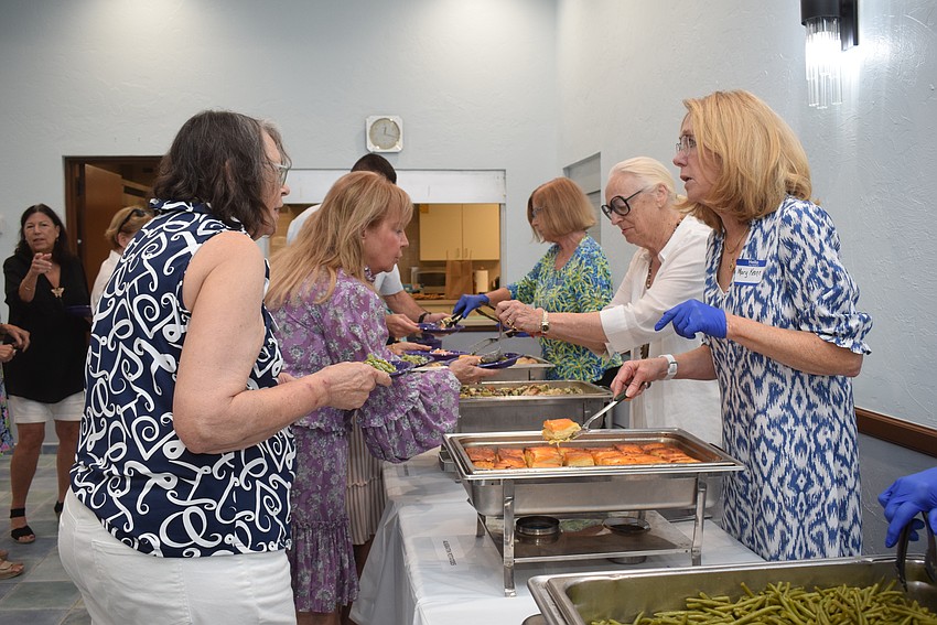 Mary Keane serving Betty Bowe at the St. Marys Women's Guild welcome back lunch.