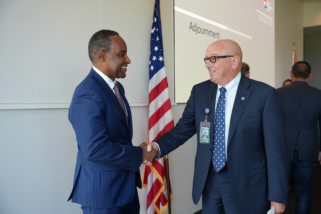 Incoming Tampa International Airport CEO Michael Stephens shakes hands with outgoing CEO Joe Lopano shorty after being chosen for the job.