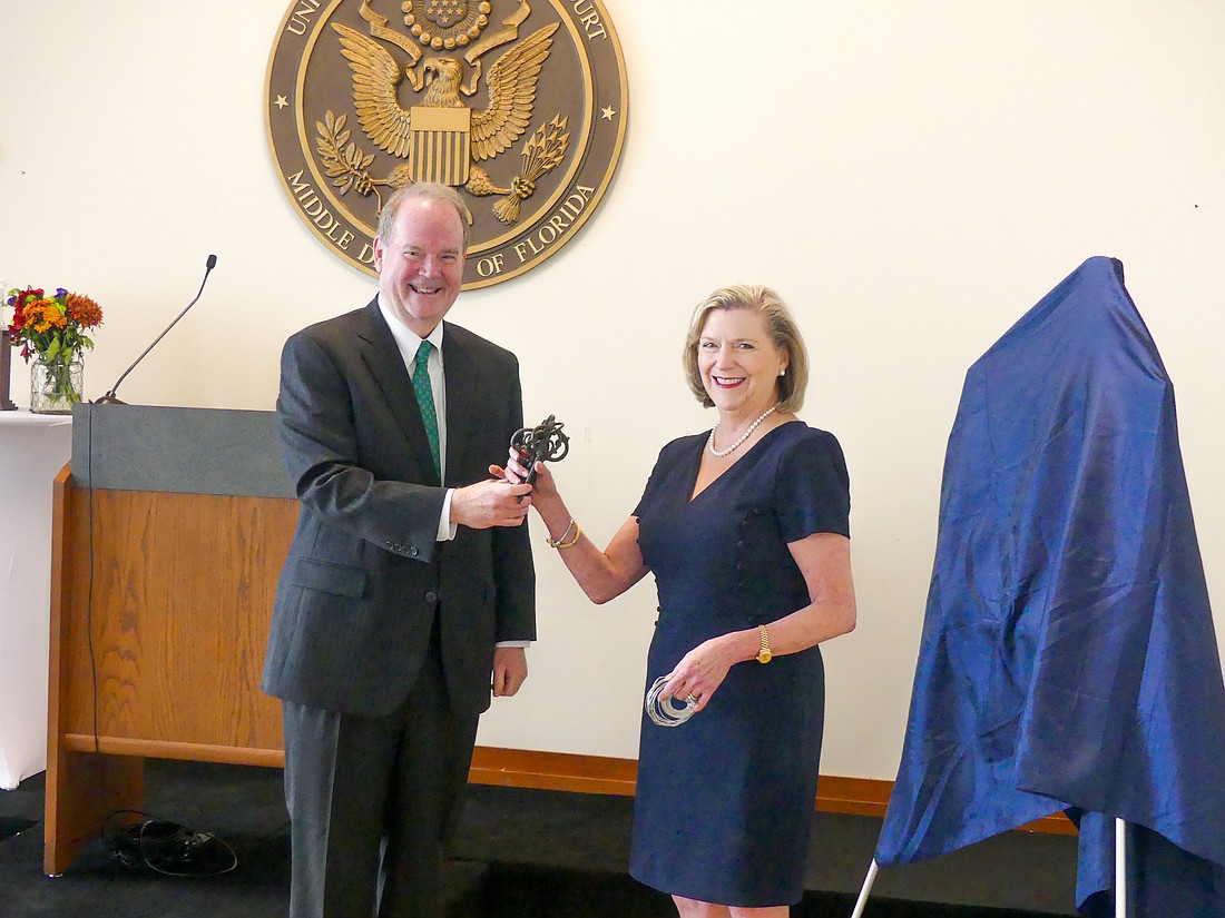 Chief U.S. District Judge for the Middle District of Florida Marcia Morales Howard accepts the keys to the district’s five courthouses from Senior U.S. District Judge Timothy Corrigan, who turned over the chief judge role to Howard on Nov. 7.