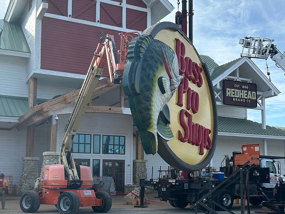 A Bass Pro Shops exterior sign is being installed Nov. 14 as the store prepares for opening  at 355 World Commerce Parkway.